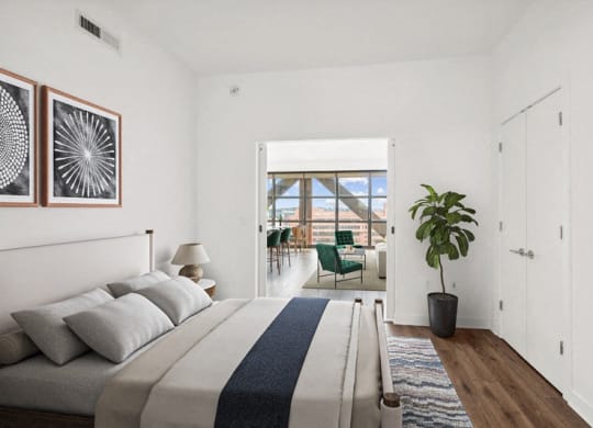 a bedroom with a bed and a door to a balcony
