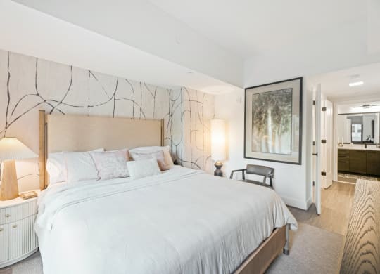a white bedroom with a large bed and a large painting on the wall at The Grace and Reva, Arlington