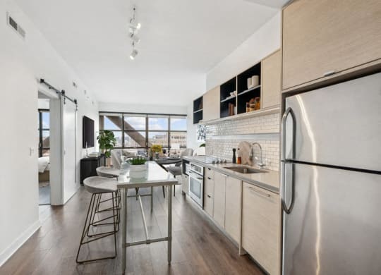 a kitchen with stainless steel appliances and a small table