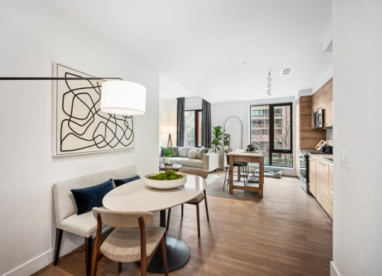 a living room and dining room with a table and chairs at The Grace and Reva, Arlington, VA