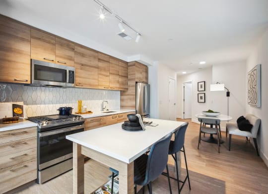 a kitchen and dining area with a table and chairs and a stove and microwave at The Grace and Reva, Arlington, 22202