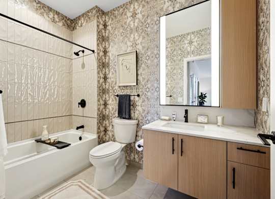 A bathroom with a white tub, toilet, and sink.