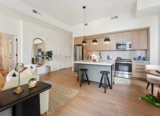 A modern kitchen with a dining table and chairs.