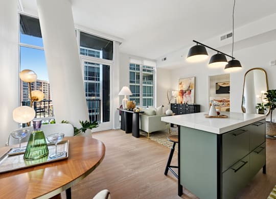 A modern kitchen with a wooden table and a green vase on it.