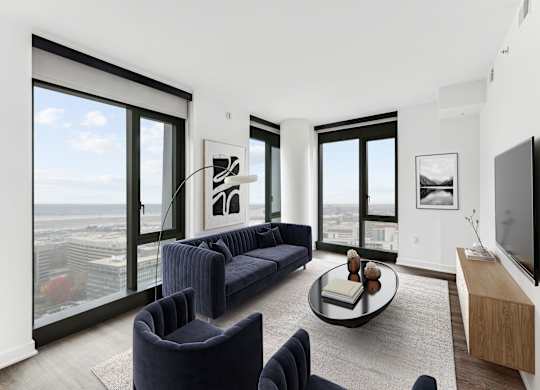 A living room with a couch, chairs, and a coffee table.