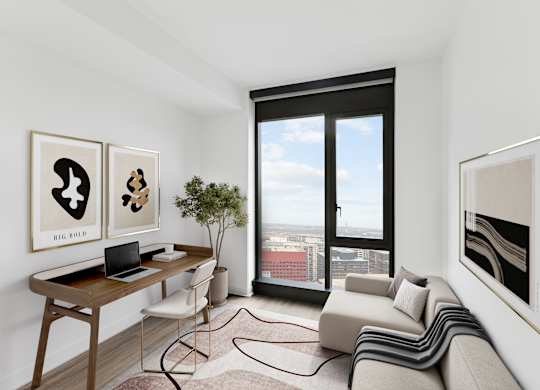 A modern living room with a laptop on the desk and a view of the city through the window.