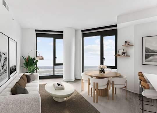 A modern living room with a large window overlooking the ocean.