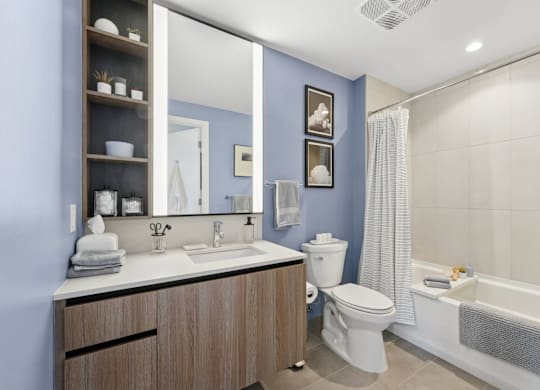 A bathroom with blue walls and a white sink.