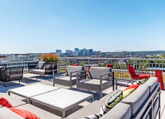 a roof deck with furniture and a view of the city