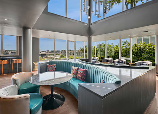 A modern lounge area with a curved sofa and a round table.