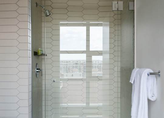 A white towel is hanging on a towel rack in a bathroom.