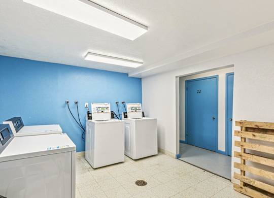 A room with a blue wall and a white door.