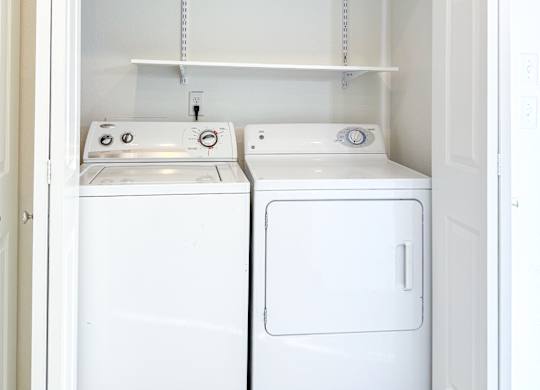 A small laundry room with a washer and dryer.