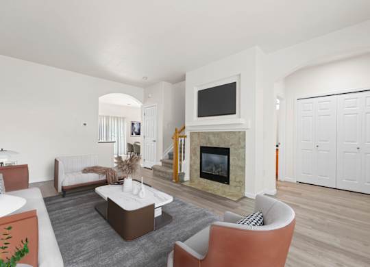A living room with a fireplace and a television.