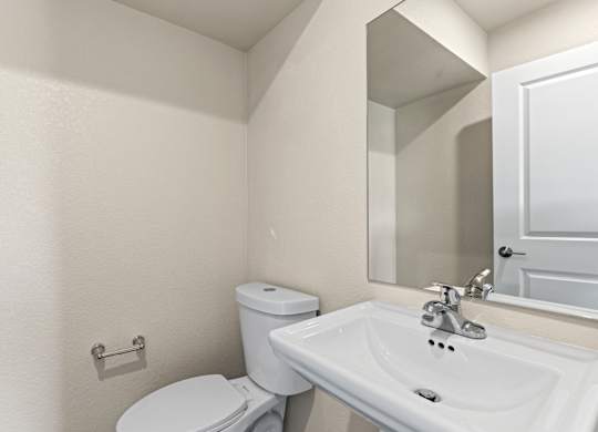Bathroom with a toilet, sink and a tub at The Townhomes at Pine Drive, Parker