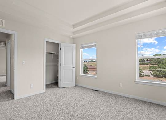 Room with a large window and a view of a residential area outside at The Townhomes at Pine Drive, Colorado, 80138