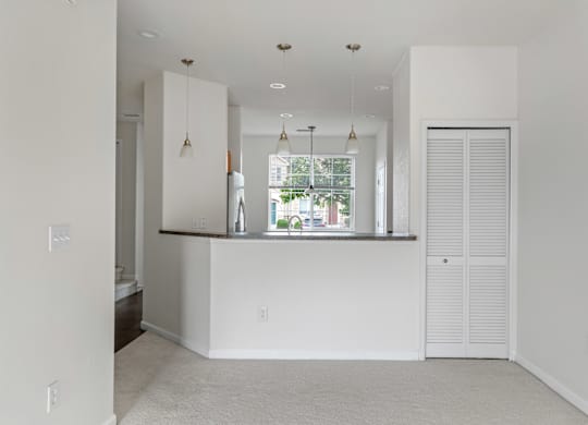 A white room with a window and a counter.