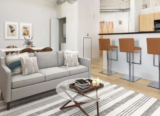 A living room with a grey couch and a coffee table.