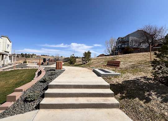 Walking paths with benches at The Townhomes at Pine Drive, Parker