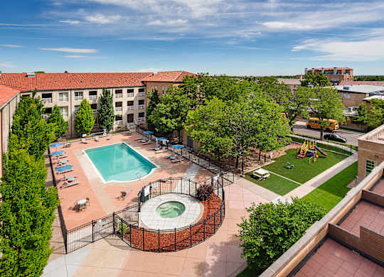 A view of a pool and playground area from a high angle.