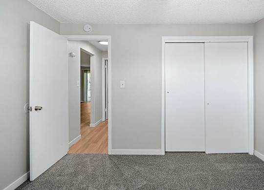 A white door is open to a hallway.