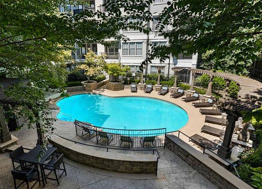 a large swimming pool in front of a hotel