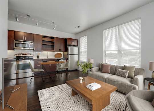 A modern kitchen with a breakfast table and a couch.