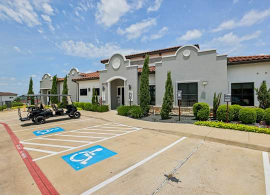 A parking lot with a disabled parking sign painted on the pavement.