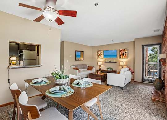 A dining room with a table set for four.