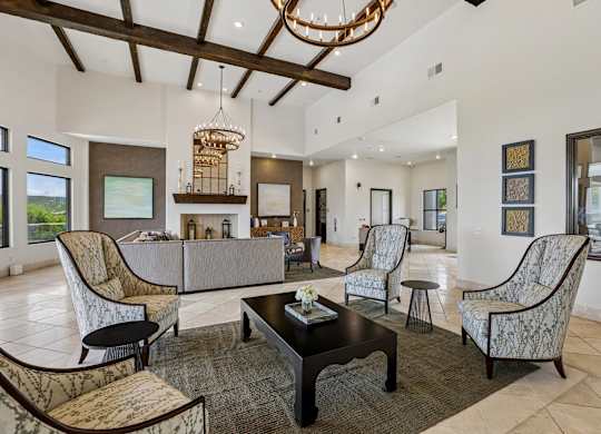 A living room with a large couch, chairs, and a coffee table.