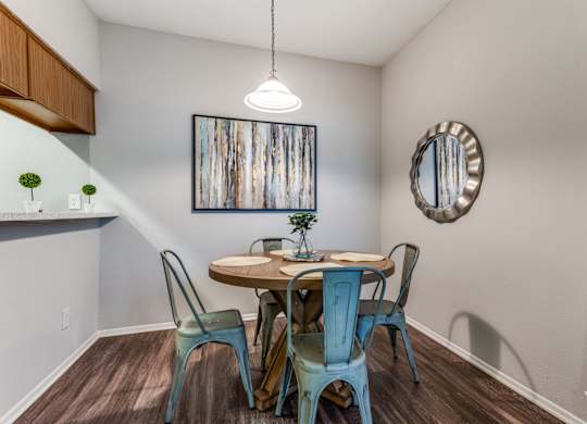 a dining area with a table and four chairs