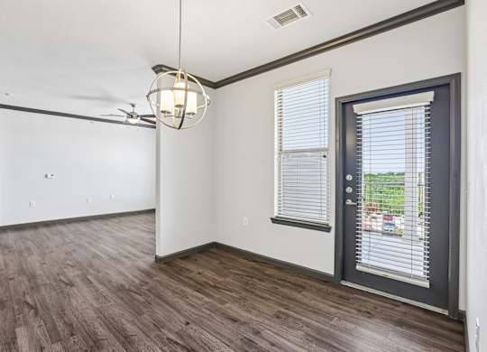 A room with a sliding door and a ceiling fan.