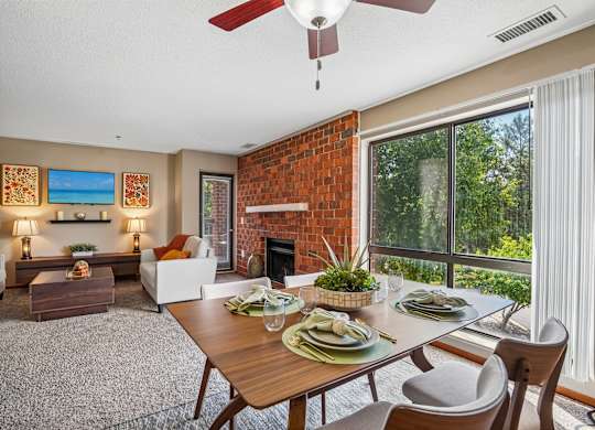 A dining room with a table set for a meal.