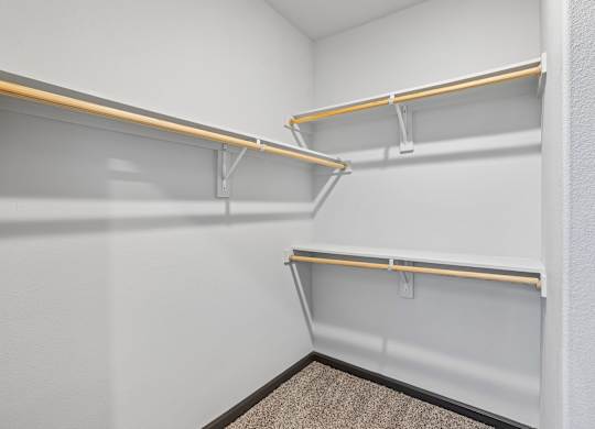 Empty white shelves in a corner of a room.