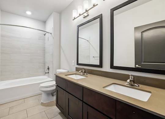 A white bathroom with a toilet, sink, and tub.
