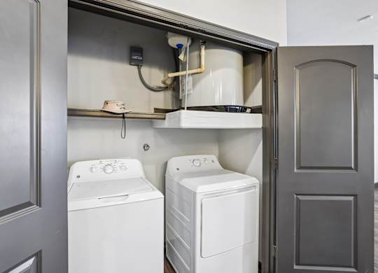 A washer and dryer are installed in a wall-mounted cabinet.