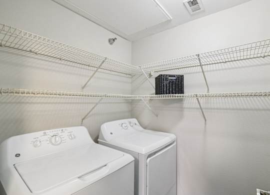A small laundry room with a washer and dryer.