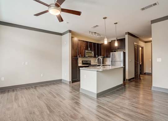 Nashville Apartments - Octave Apartments - Open concept floorplan with wood style floors granite countertops and gourmet kitchen with a large kitchen island and stainless steel appliances