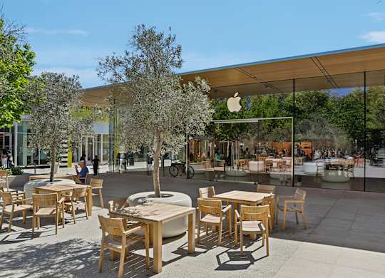 A large outdoor seating area with wooden tables and chairs.