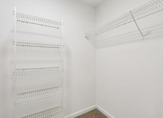Empty white shelves in a room.