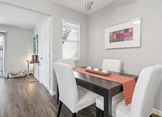 A dining room with a table set for two.
