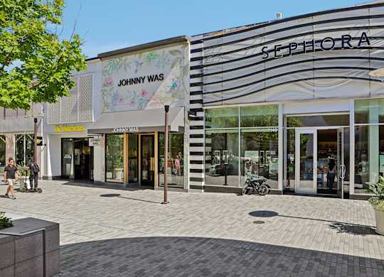 A Sephora store is located next to a Johnny WAS store.