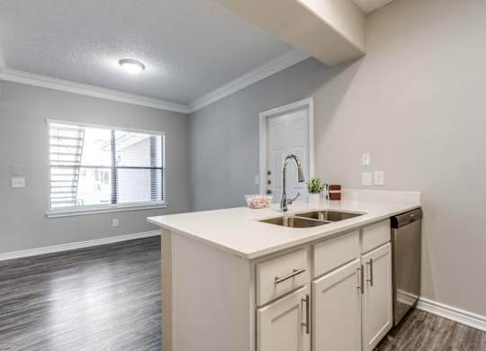 an empty kitchen with a sink and a window