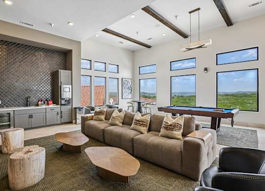 A living room with a brown couch and a wooden coffee table.