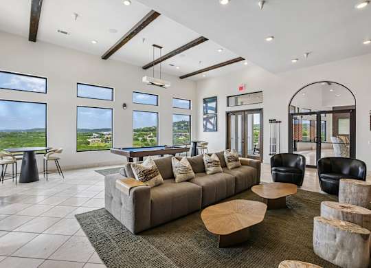 A spacious living room with a large couch and a coffee table.