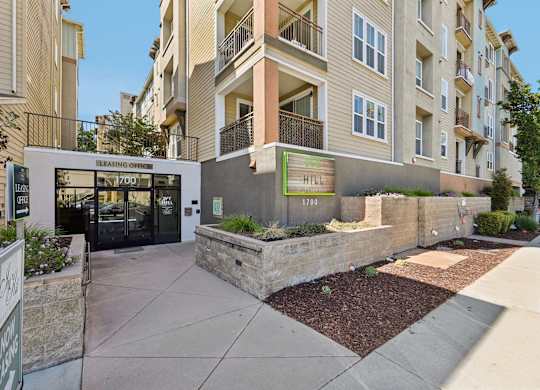 The image shows a building with a leasing office and a sign that reads