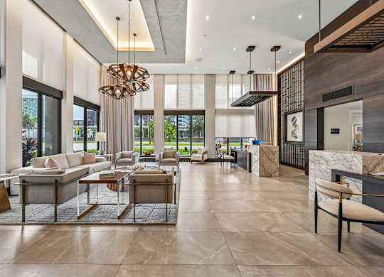 A modern living room with a large chandelier and a marble floor.