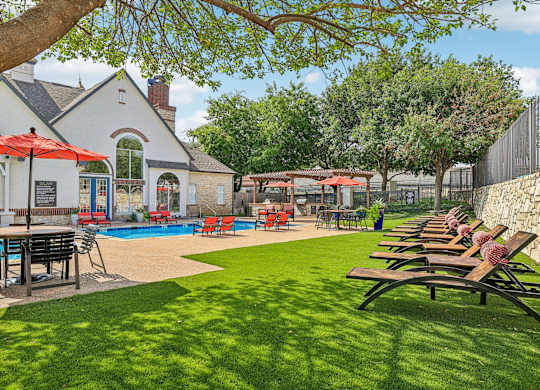 A pool area with a building in the background.