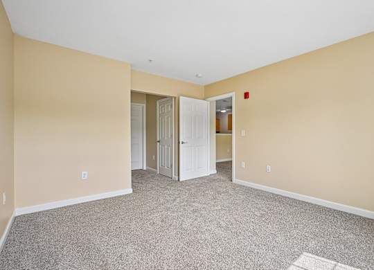 A room with carpeted floor and white walls.