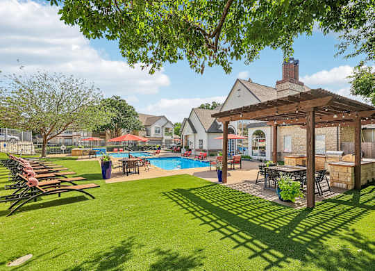 A backyard with a pool and a gazebo.